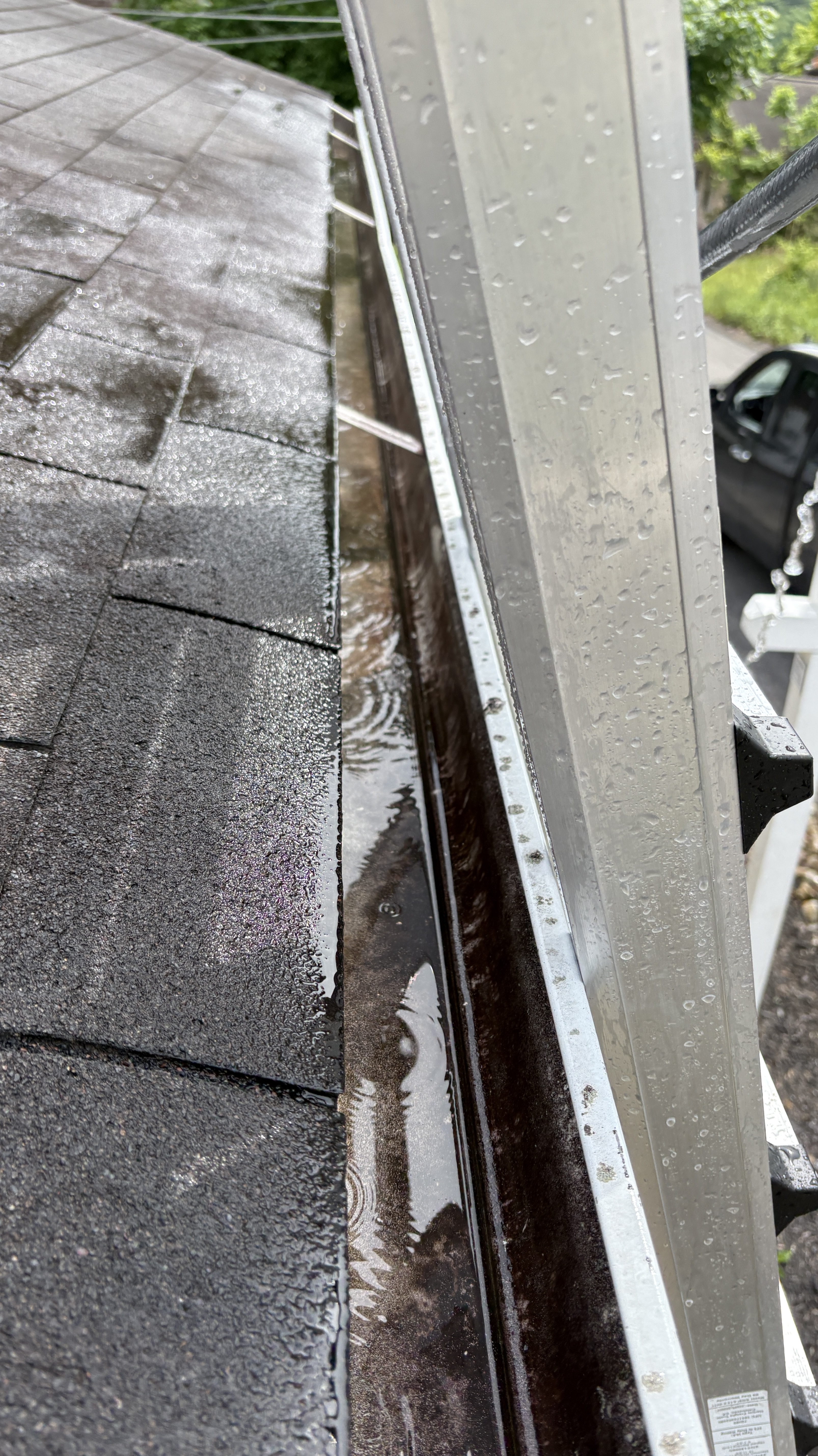 Clean, water-flowing gutter alongside a roofline